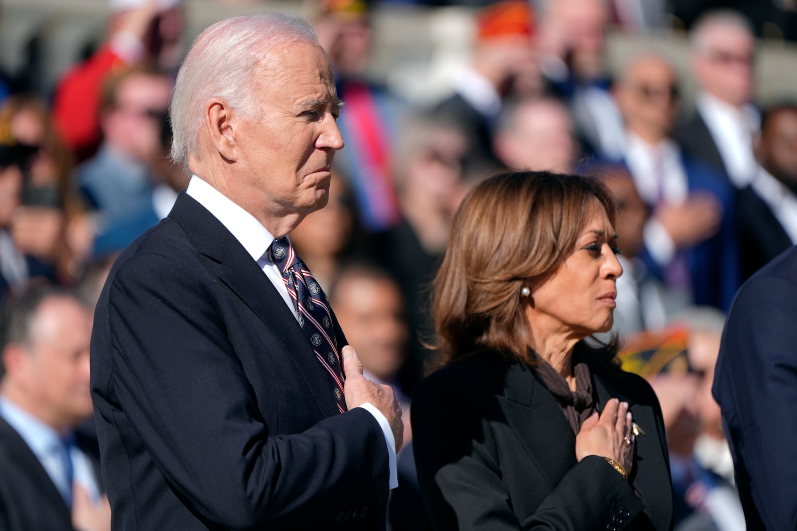 President Joe Biden, left, and Vice President Kamala Harris look on during a wreath laying ceremony at the Tomb of the Unknown Soldier on National Veterans Day Observance at Arlington National Cemetery in Arlington, Va., Monday, Nov. 11, 2024. (AP Photo/Mark Schiefelbein)