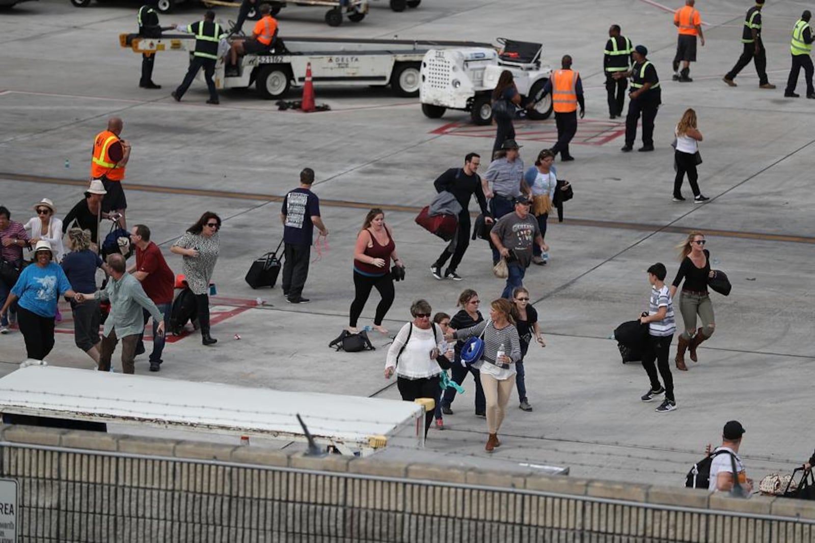 Passengers ran for cover on the tarmac of Ft. Lauderdale-Hollywood Airport as a gunman began shooting inside the baggage claim area.