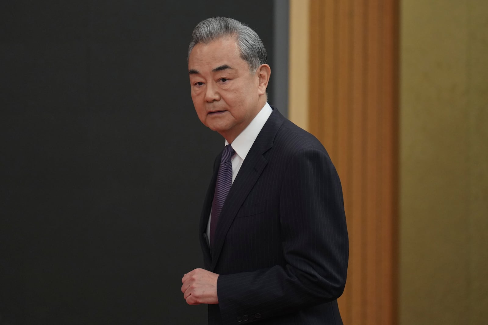 Chinese Foreign Minister Wang Yi arrives for a press conference on the sideline of the National People's Congress in Beijing, Friday, March 7, 2025. (AP Photo/Ng Han Guan)