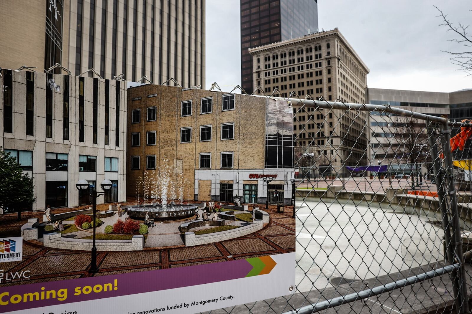 Work on the revamping of Courthouse Square continues. The fence around the fountain along with a rendering of the finished work is still in place. JIM NOELKER/STAFF