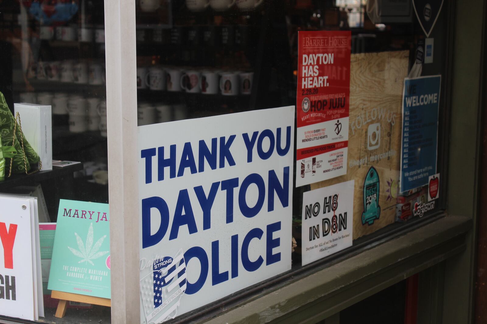 Six months after a 24-year-old Bellbrook man killed nine people in the Oregon District during the worst mass shooting in Ohio history, literal signs of strength, appreciation, resilience and the determination to “do something” about gun violence can be found throughout the historic neighborhood. Heart Mercantile displays a "Thank you Dayton Police" sign. AMELIA ROBINSON/STAFF