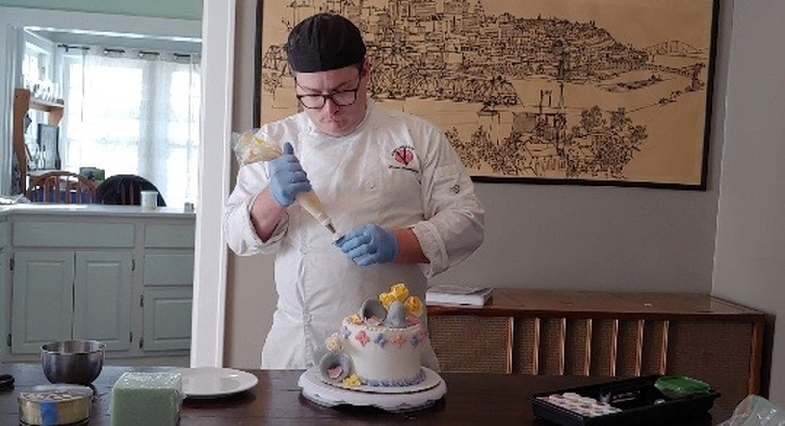 This is Sinclair Community College student Bobbie Baker decorating a cake he prepared for his final project in the college’s Baking and Pastry certificate program. The class transitioned to on-line only when in-person classes were canceled due to the COVID-19 crisis. Baker, of Springfield, and other students submit their projects using video and photographs.