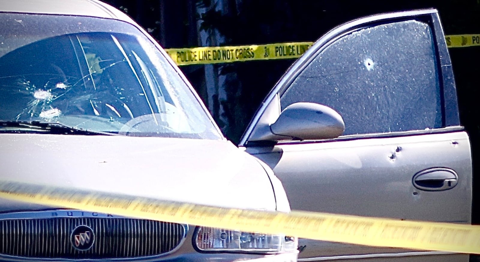 A car with bullet holes is seen Saturday morning, Oct. 19, 2024, on Rosedale Drive in Dayton following a deadly officer-involved shooting. MARSHALL GORBY/STAFF