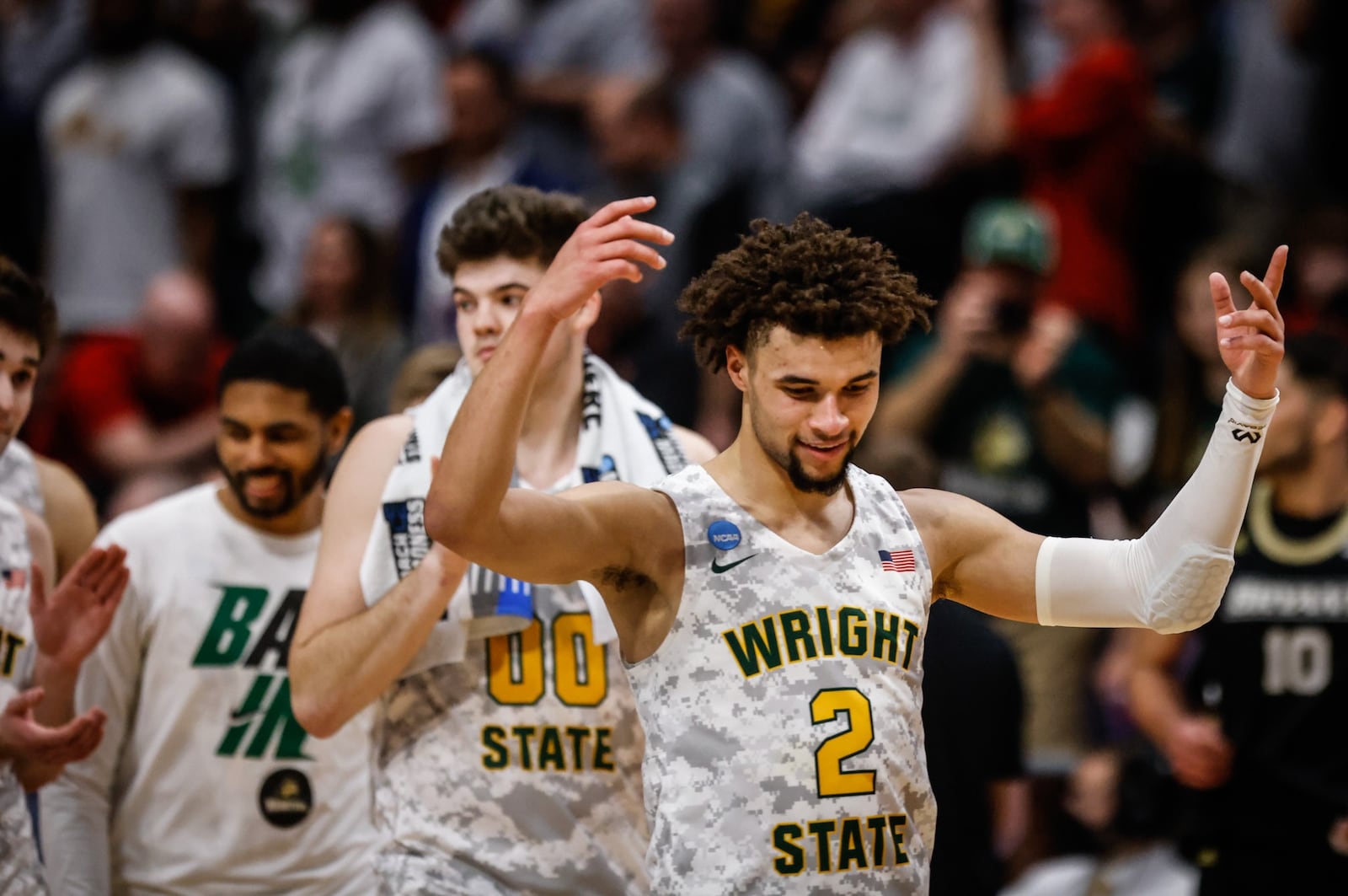 WSU guard, Tanner Holden reacts to his teams first NCAA tournament win at UD Arena Wednesday night. JIM NOELKER/STAFF