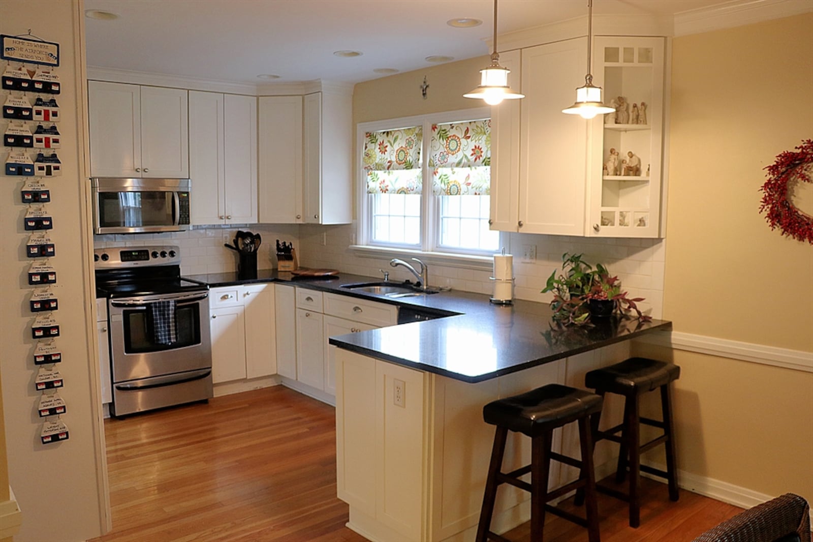 In the kitchen, white cabinetry wraps around all the appliances, which include a range, microwave and dishwasher.