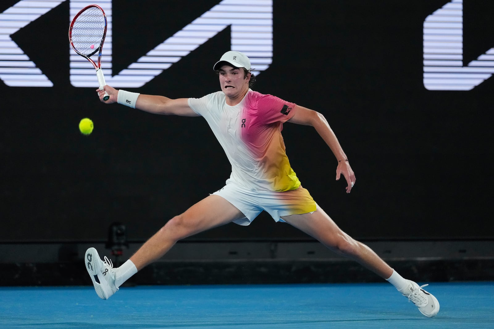 Joao Fonseca of Brazil plays a forehand return to Andrey Rublev of Russia during their first round match at the Australian Open tennis championship in Melbourne, Australia, Tuesday, Jan. 14, 2025. (AP Photo/Asanka Brendon Ratnayake)