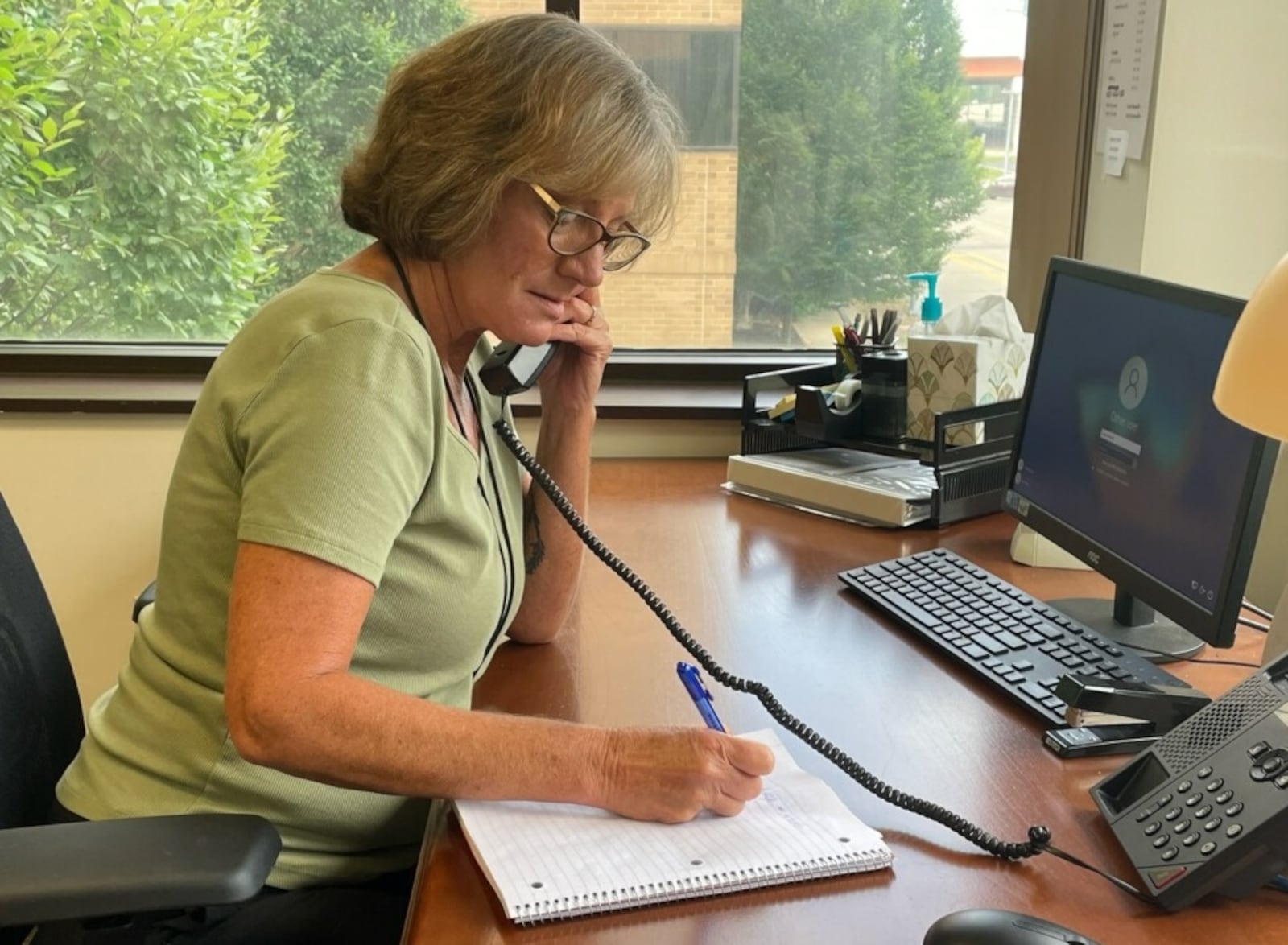 Laura R., clinical supervisor, at the hotline call room at the Artemis Center in Dayton. SAMANTHA WILDOW/STAFF