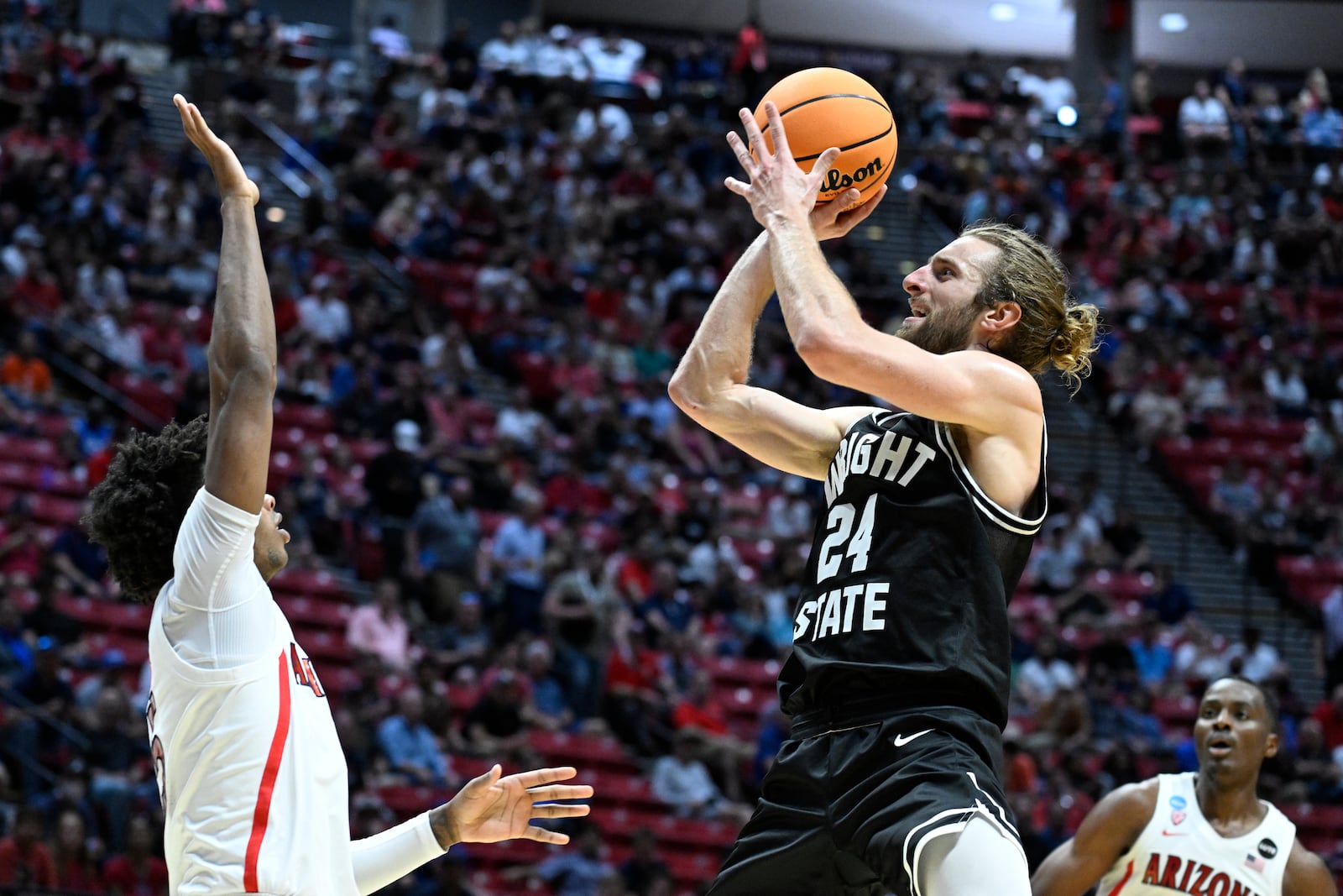 Wright State guard Tim Finke (24) shoots against Arizona during the first half of a first-round NCAA college basketball tournament game, Friday, March 18, 2022, in San Diego. (AP Photo/Denis Poroy)