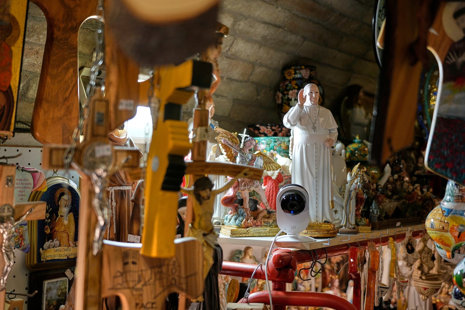 A statue of Pope Francis sits among other religious items at a shop in Assisi, Italy, Saturday, March 1, 2025. (AP Photo/Gregorio Borgia)