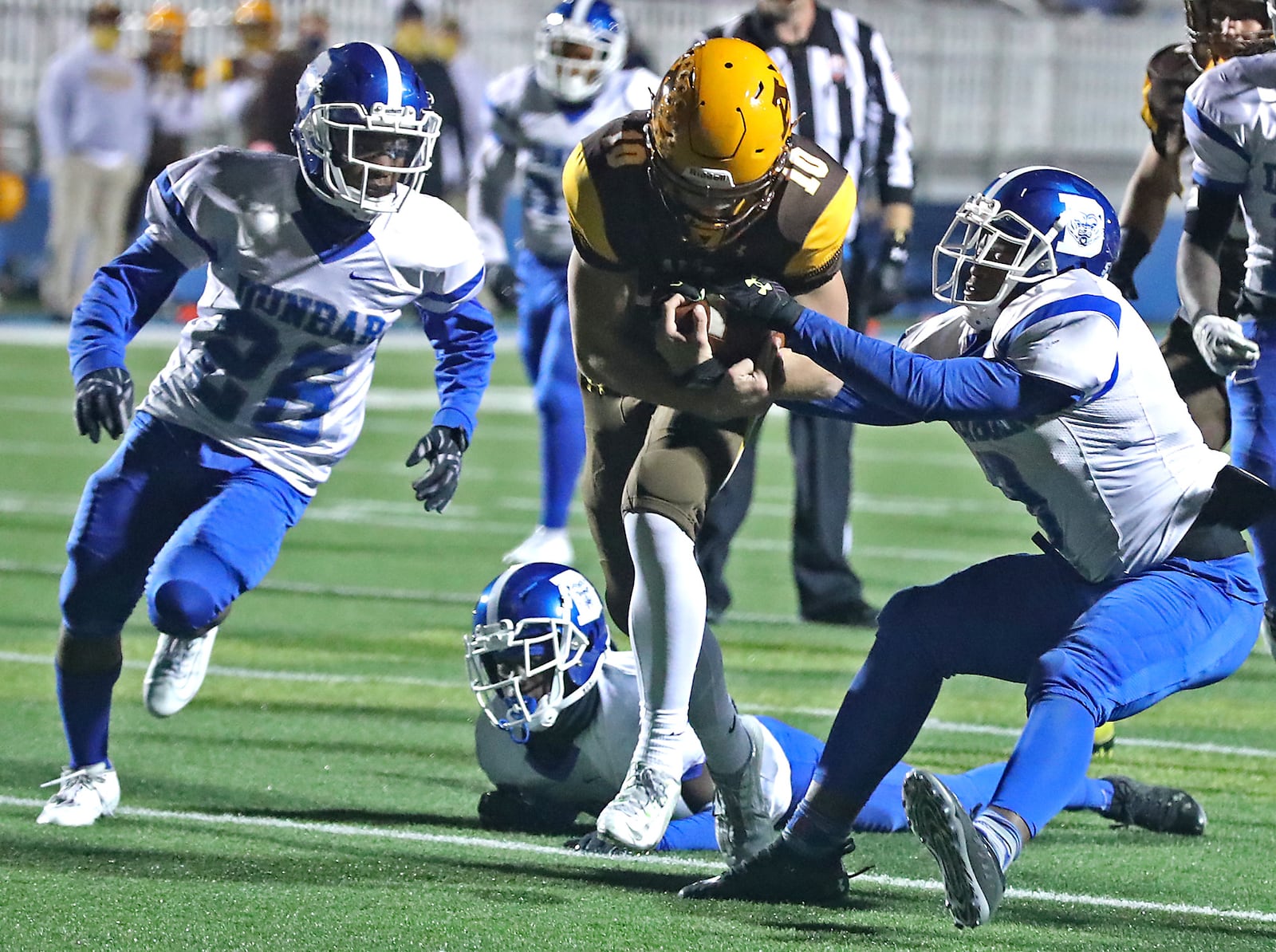 Alter's Brian Shane carries the ball as Dunbar's Keishaun Black, left, and Alex Dawkins thy to stop him during Friday's game. BILL LACKEY/STAFF