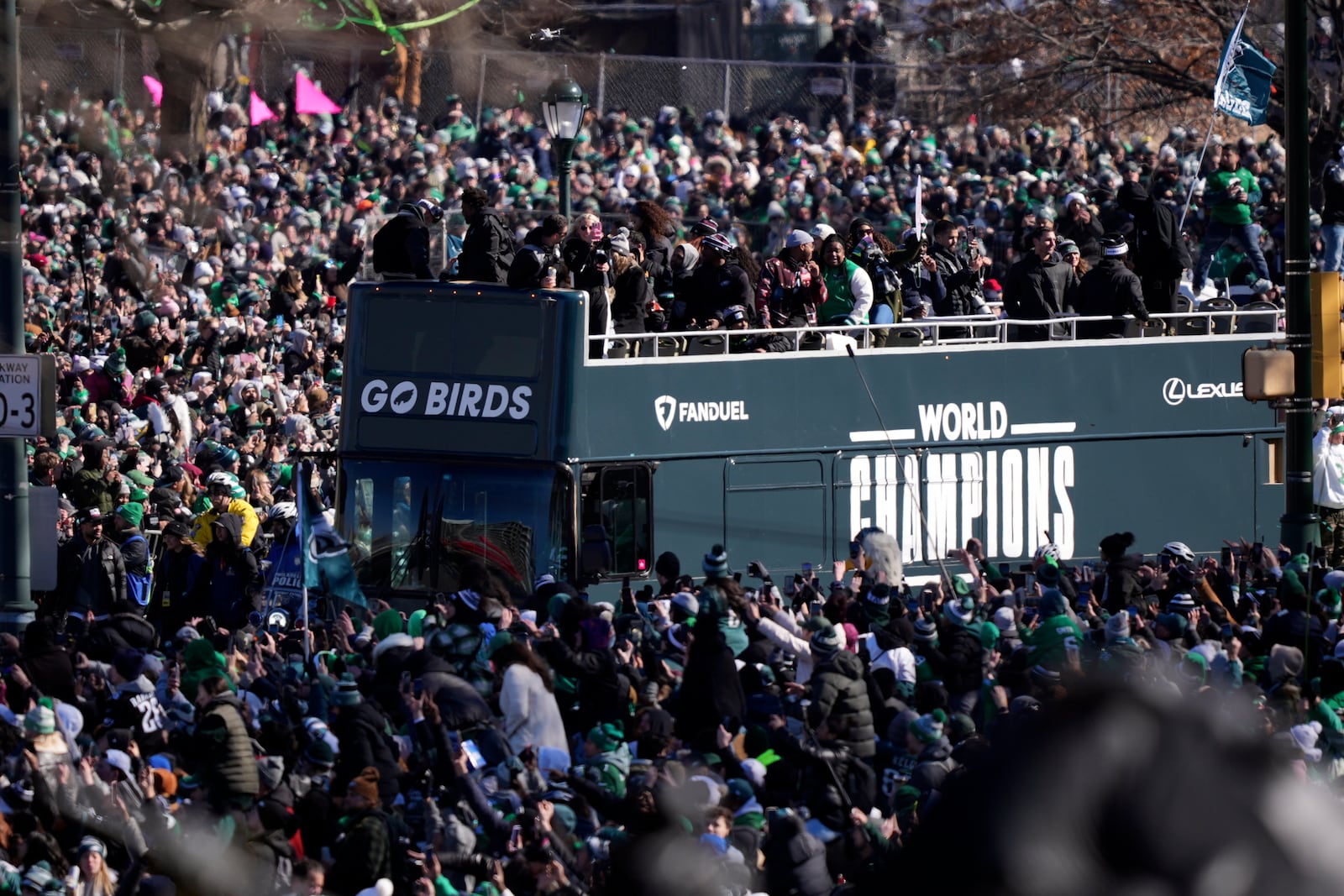 Fans looks on as bus carrying players pass by during the Philadelphia Eagles' NFL football Super Bowl 59 parade and celebration, Friday, Feb. 14, 2025, in Philadelphia.(AP Photo/Matt Rourke)