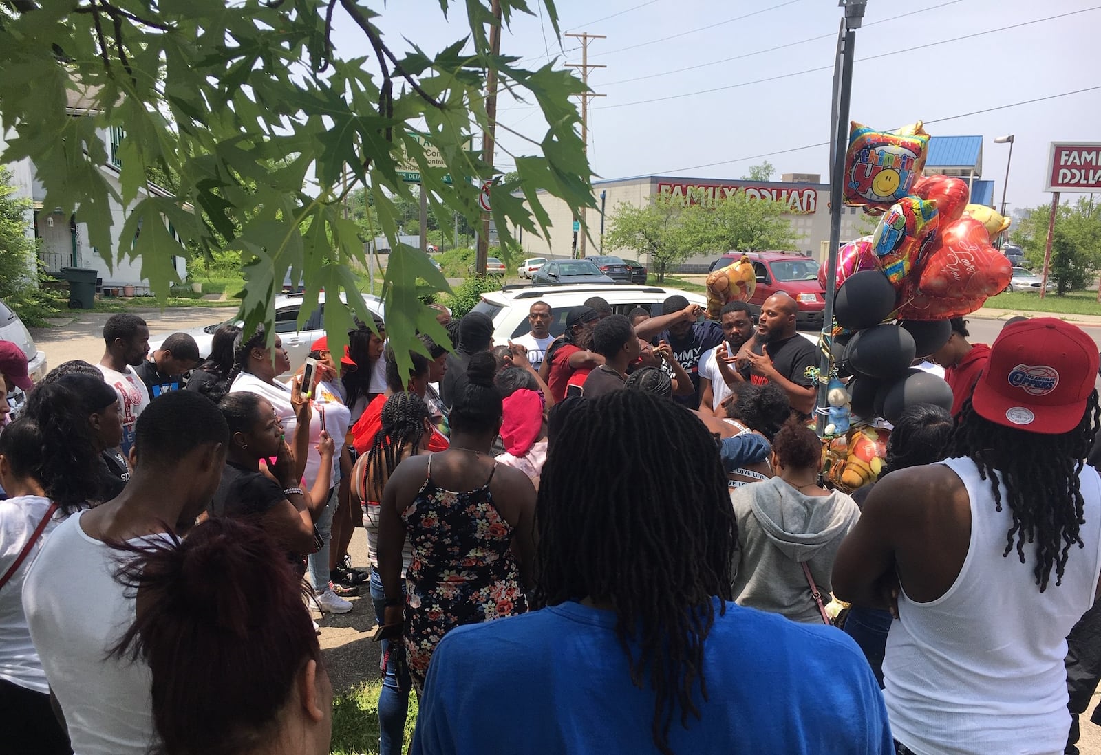 Dozens gather to pay their respects near the intersection of Hillcrest and Salem avenues in Dayton where Michael Hall, 31, was shot and killed Tuesday morning. An 18-year-old girl was also critically injured in the shooting. (Mike Campbell/Staff)