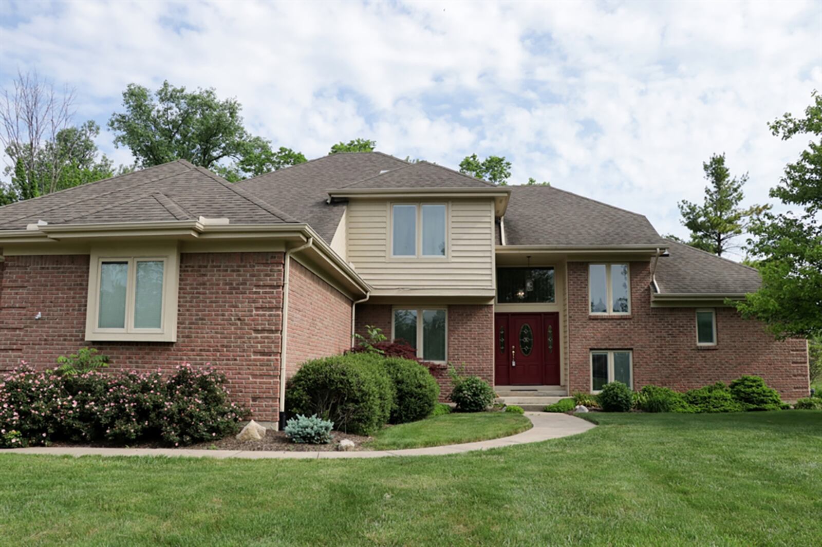 The custom 2-story, which has about 3,930 sq. ft. of living space, offers a first-floor main bedroom, a great room with volume ceilings and 3 upstairs bedrooms. CONTRIBUTED PHOTO BY KATHY TYLER