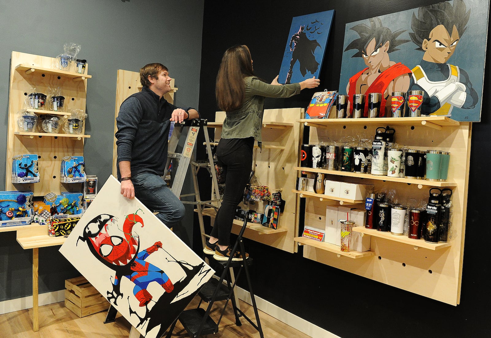 Adam Remillard and his wife Erin, owners of Monocle Comics & Coffee prepare for the grand opening of their business located at 22 S. Main Street in Miamisburg. MARSHALL GORBY\STAFF