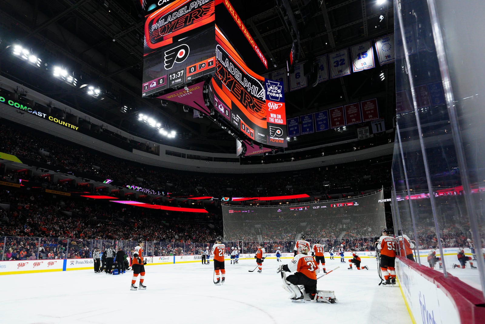 Referee Mitch Dunning, bottom left, lies on the ice after an injury during the first period of an NHL hockey game between the Philadelphia Flyers and the Colorado Avalanche, Monday, Nov. 18, 2024, in Philadelphia. (AP Photo/Derik Hamilton)