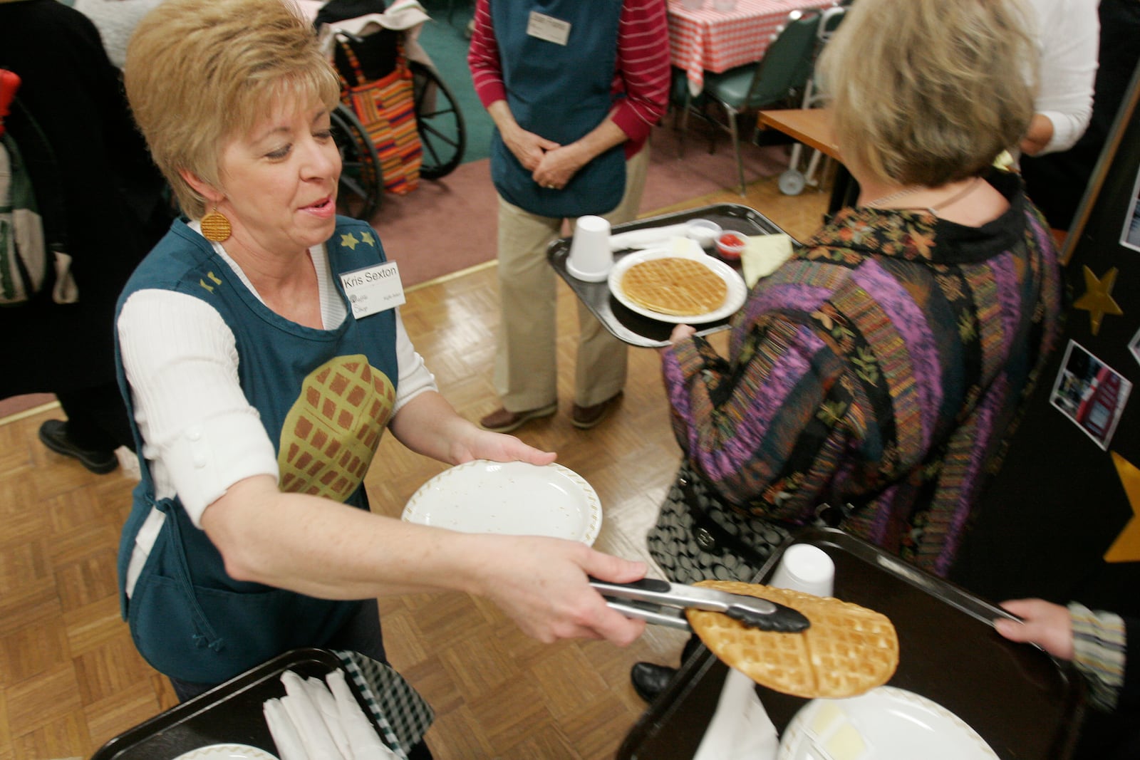 Kris Sexton serves up waffles at the 82nd annual Waffle Shop fundraiser held at Christ Episcopal Church. The Waffle Shop raising money for programs that serve downtown Dayton. The event goes from Nov. 15 thru 18 and from 11am to 2pm. STAFF PHOTO JIM NOELKER