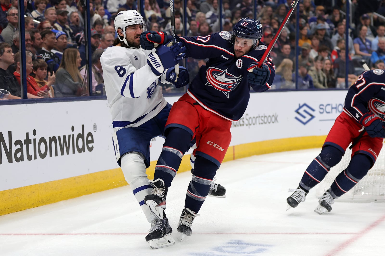 Columbus Blue Jackets forward Justin Danforth, right, checks Toronto Maple Leafs defenseman Christopher Tanev during the second period of an NHL hockey game in Columbus, Ohio, Tuesday, Oct. 22, 2024. (AP Photo/Paul Vernon)