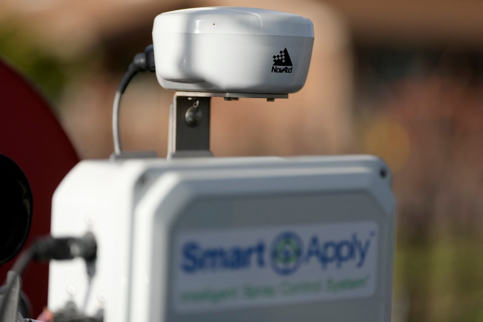 A NovAtel LiDAR device is shown above a Smart Apply Intelligent Spray Control System as Tyler Klick, Partner/Viticulturist of Redwood Empire Vineyard Management, during an interview on AI technology used in the wine industry in Geyserville, Calif., Friday, Jan. 24, 2025. (AP Photo/Jeff Chiu)