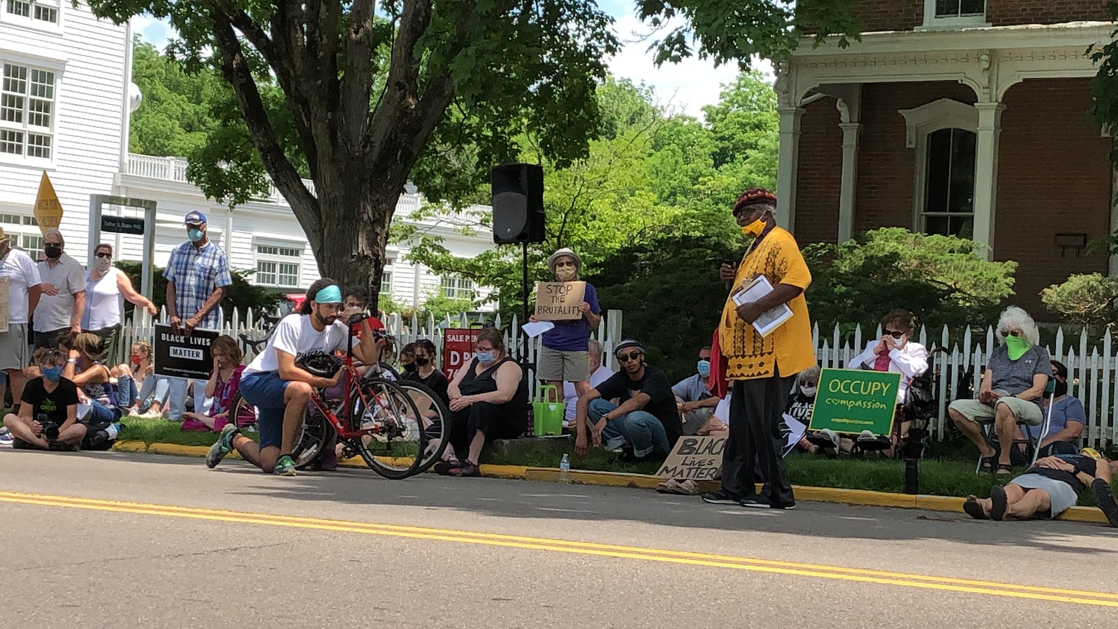 On Saturday in Yelllow Springs protesters observe nine minutes of silence as Bomani Moyenda (standing just to the right) talks about the final moments of George Floyd's life as he died in the custody of Minneapolis police on Memorial Day.