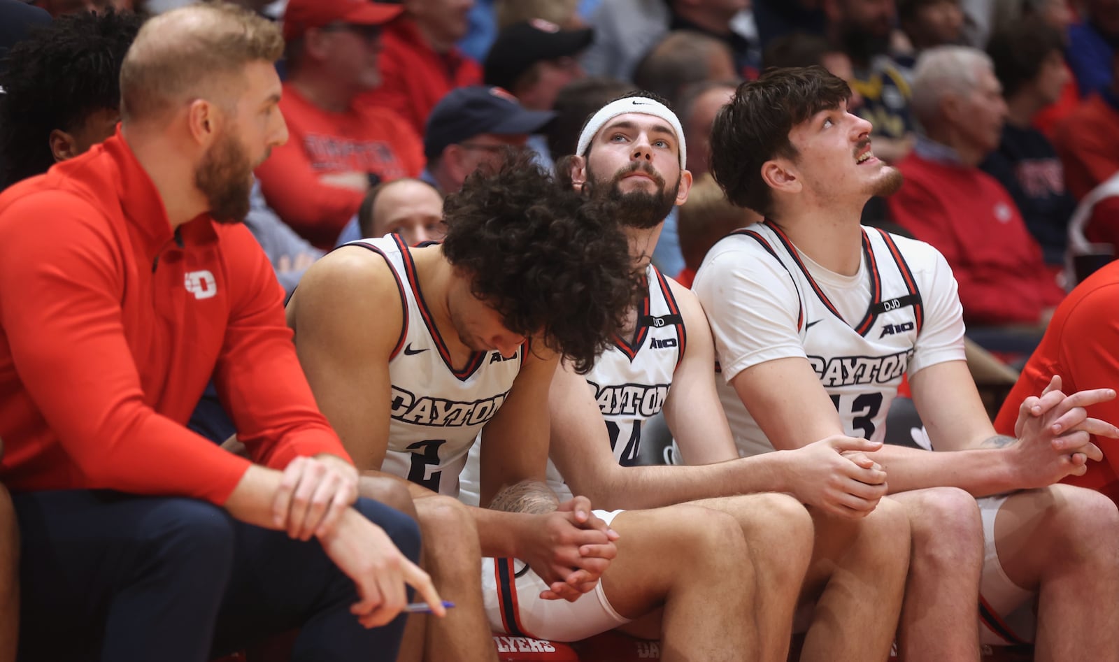 Dayton's Nate Santos, second from left, hangs his head in the second half during a game against George Mason on Wednesday, Jan. 15, 2025, at UD Arena. David Jablonski/Staff