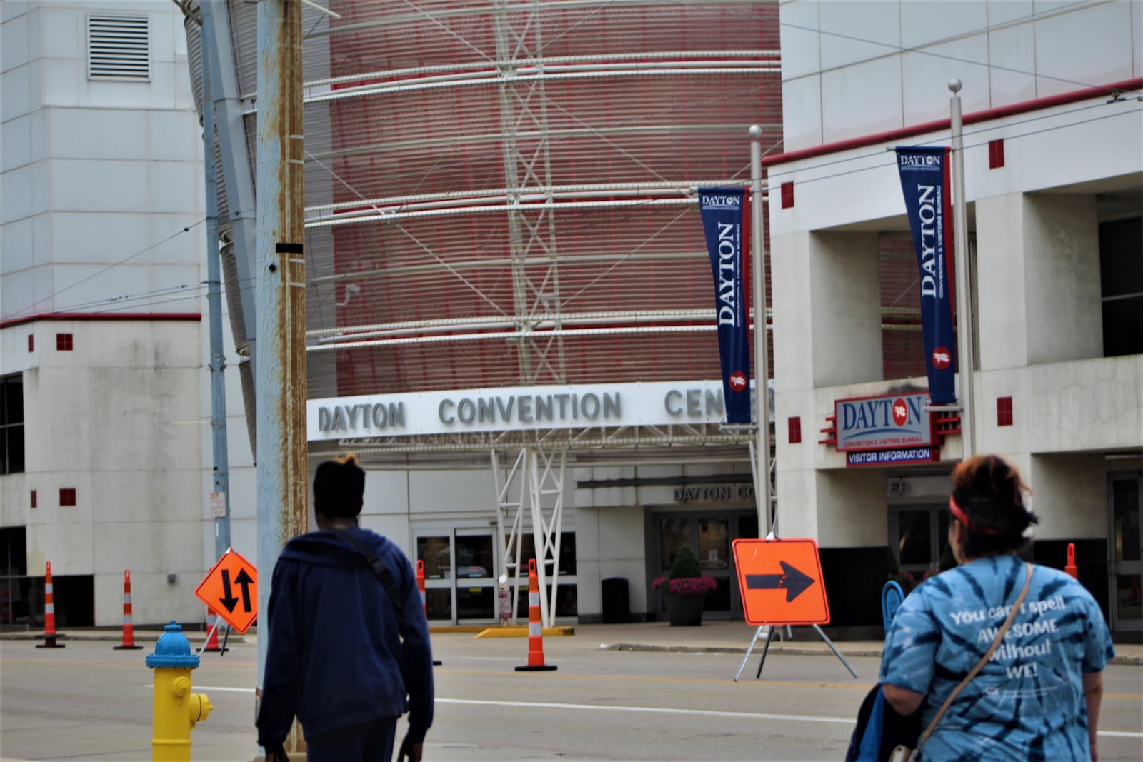 Pedestrians walk by the Dayton Convention Center in downtown Dayton. CORNELIUS FROLIK / STAFF