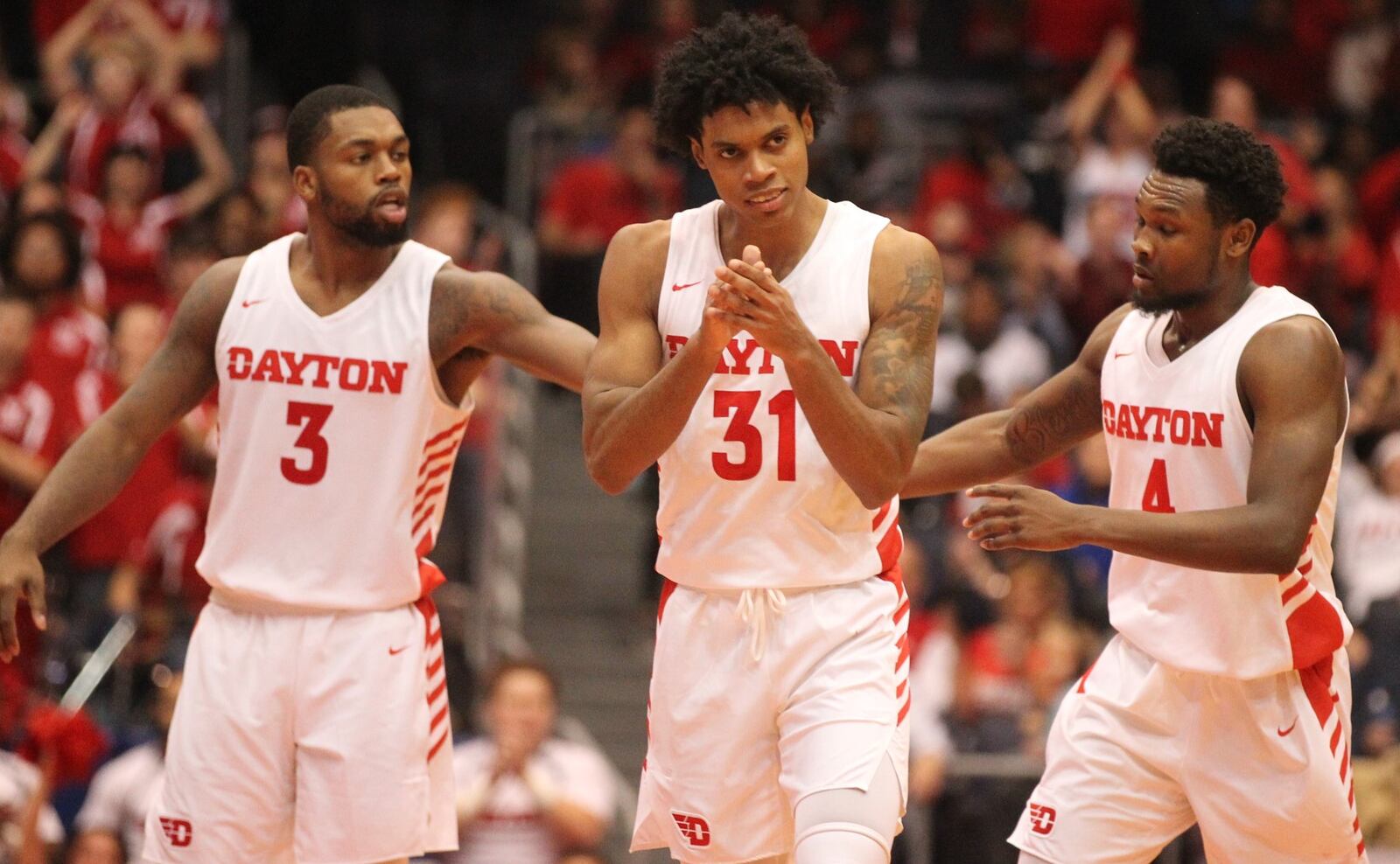 Dayton’s Trey Landers, Jhery Matos and Jordan Davis celebrate a basket during a game against Purdue Fort Wayne on Friday, Nov. 16, 2018, at UD Arena. David Jablonski/Staff