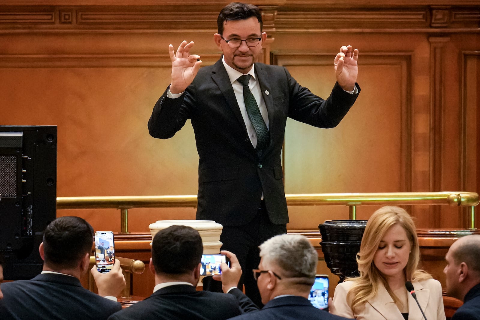 A member of parliament casts his vote during a confidence vote for Romanian Prime Minister designate Marcel Ciolacu, the leader of the Social Democratic party, and his team at the parliament in Bucharest, Romania, Monday, Dec. 23, 2024. (AP Photo/Vadim Ghirda)