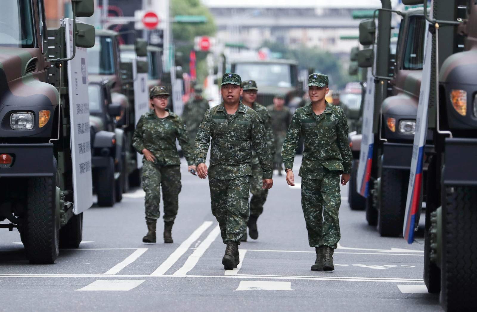 Soldiers walk among the army trucks during National Day celebrations in front of the Presidential Building in Taipei, Taiwan, Thursday, Oct. 10, 2024. (AP Photo/Chiang Ying-ying)