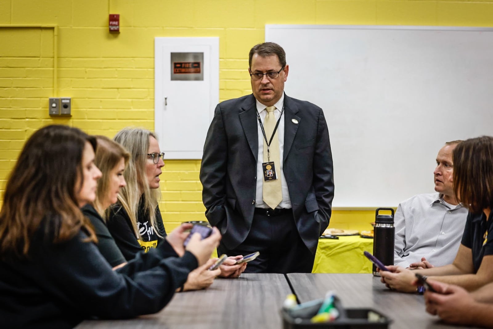 Centerville schools Superintendent Jon Wesney talks to district administrators before checking updated results on Centerville's school levy Nov. 7, 2023. Voters rejected the tax levy. Jim Noelker/Staff