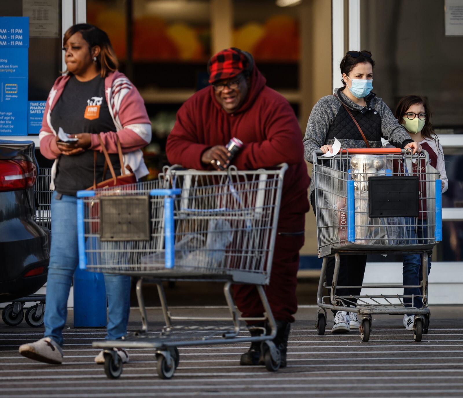 Walmart customers leave the store on South Dixie Drive in Kettering, some wearing masks and some not. More than 4,000 people with COVID-19 were hospitalized in Ohio for the third day in a row. The last time more Ohioans were being treated in the hospital for COVID was  on Jan. 12. Jim Noelker/Staff