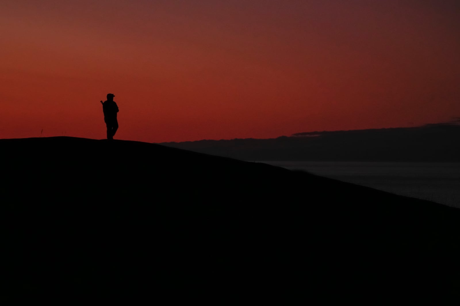 A person watches for polar bears near Hudson Bay, Saturday, Aug. 3, 2024, in Churchill, Manitoba. (AP Photo/Joshua A. Bickel)