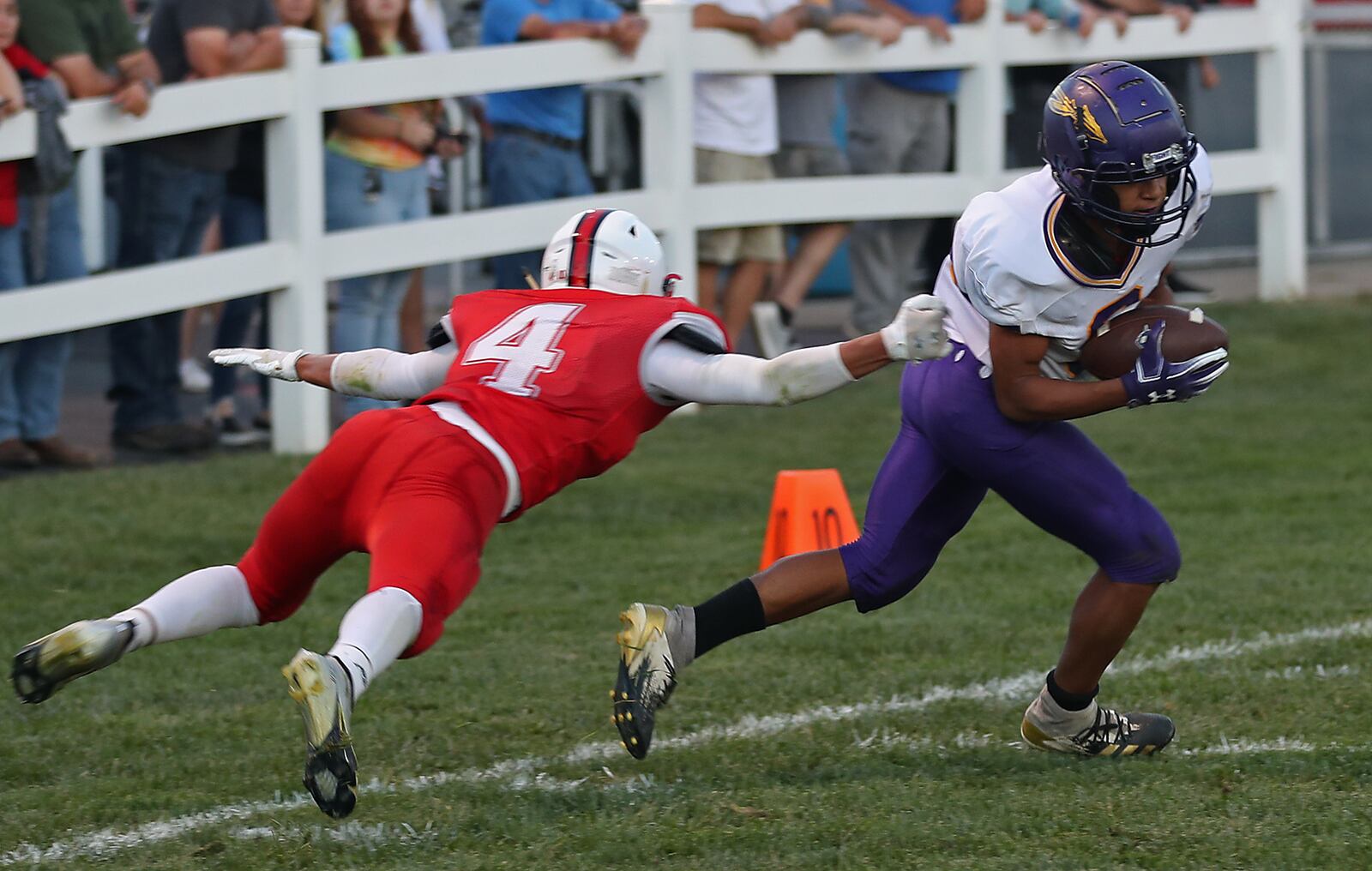 Mechanicsburg's Jayden Roland forces Southeastern's Jonah Asebrook to miss a tackle as he catches a pass and runs in for a touchdown. BILL LACKEY/STAFF