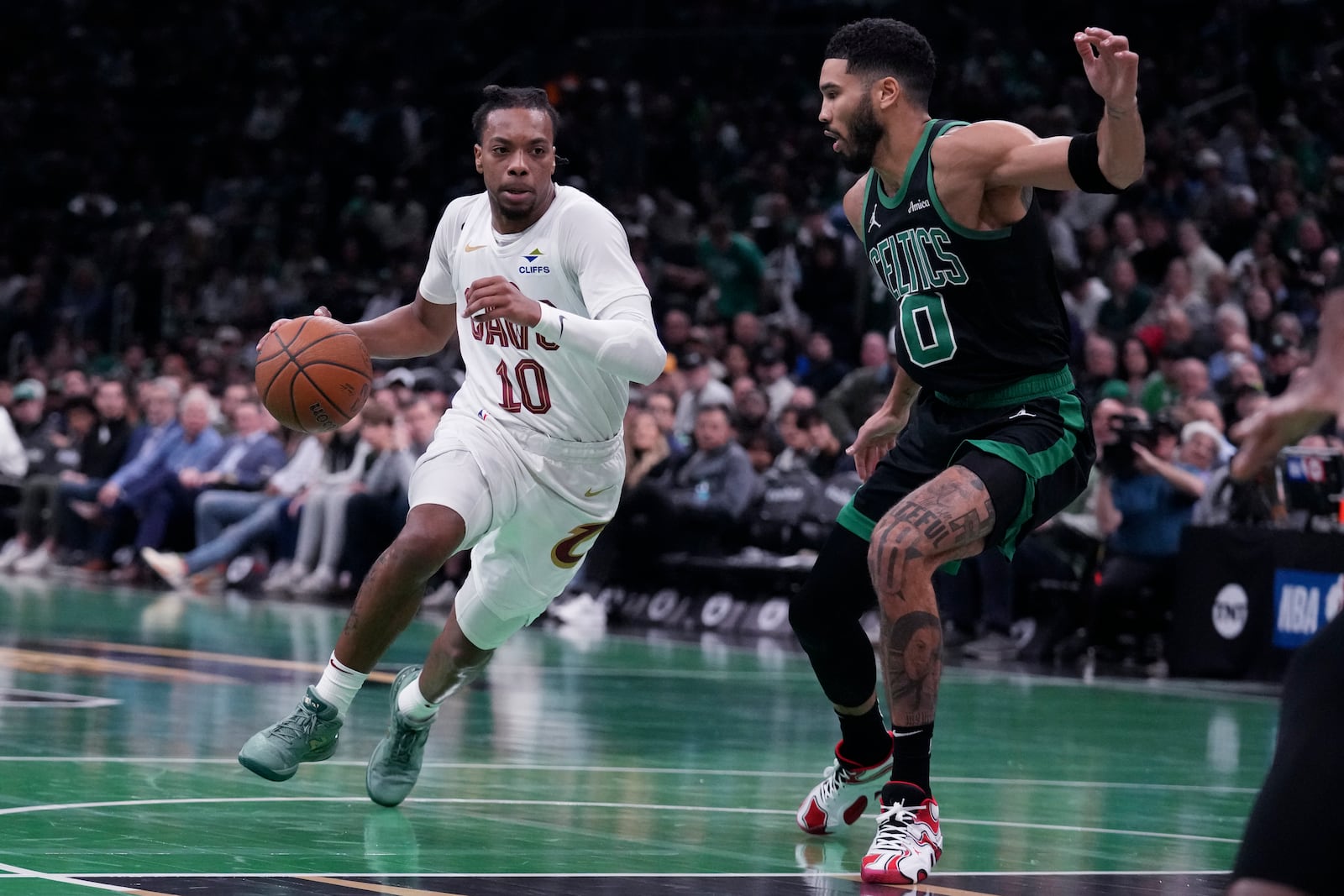 Cleveland Cavaliers guard Darius Garland (10) drives to the basket against Boston Celtics forward Jayson Tatum (0) during the first half of an Emirates NBA Cup basketball game, Tuesday, Nov. 19, 2024, in Boston. (AP Photo/Charles Krupa)