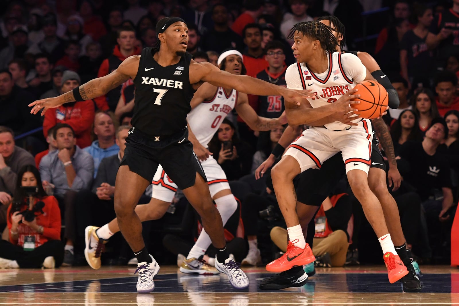 St. John's guard Simeon Wilcher, right, dribbles the ball against Xavier guard Ryan Conwell (7) during the first half of an NCAA college basketball game Wednesday, Jan. 22, 2025, in New York. (AP Photo/Pamela Smith)