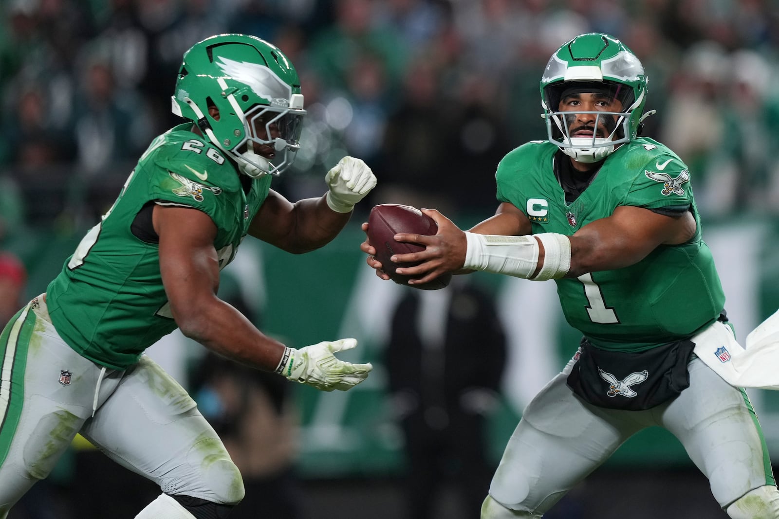 Philadelphia Eagles quarterback Jalen Hurts (1) hands off to Eagles running back Saquon Barkley (26) during the second half of an NFL football game against the Jacksonville Jaguars on Sunday, Nov. 3, 2024, in Philadelphia. (AP Photo/Matt Slocum)