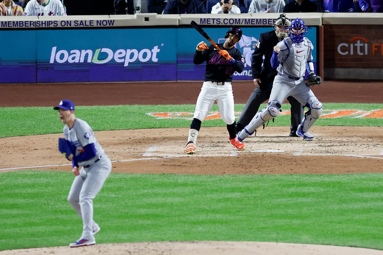 Los Angeles Dodgers pitcher Walker Buehler and catcher Will Smith celebrate after New York Mets' Francisco Lindor strike out with the bases loaded to end the second inning in Game 3 of a baseball NL Championship Series, Wednesday, Oct. 16, 2024, in New York. (AP Photo/Adam Hunger)