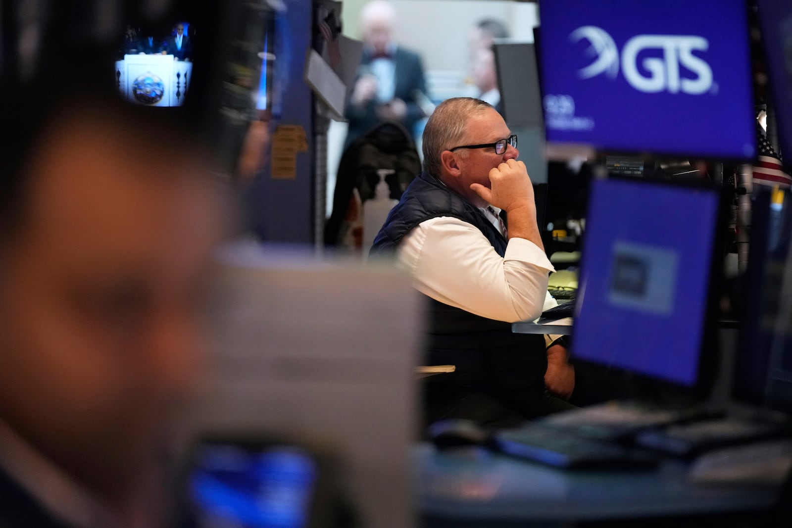 People work on the floor at the New York Stock Exchange in New York, Tuesday, March 4, 2025. (AP Photo/Seth Wenig)