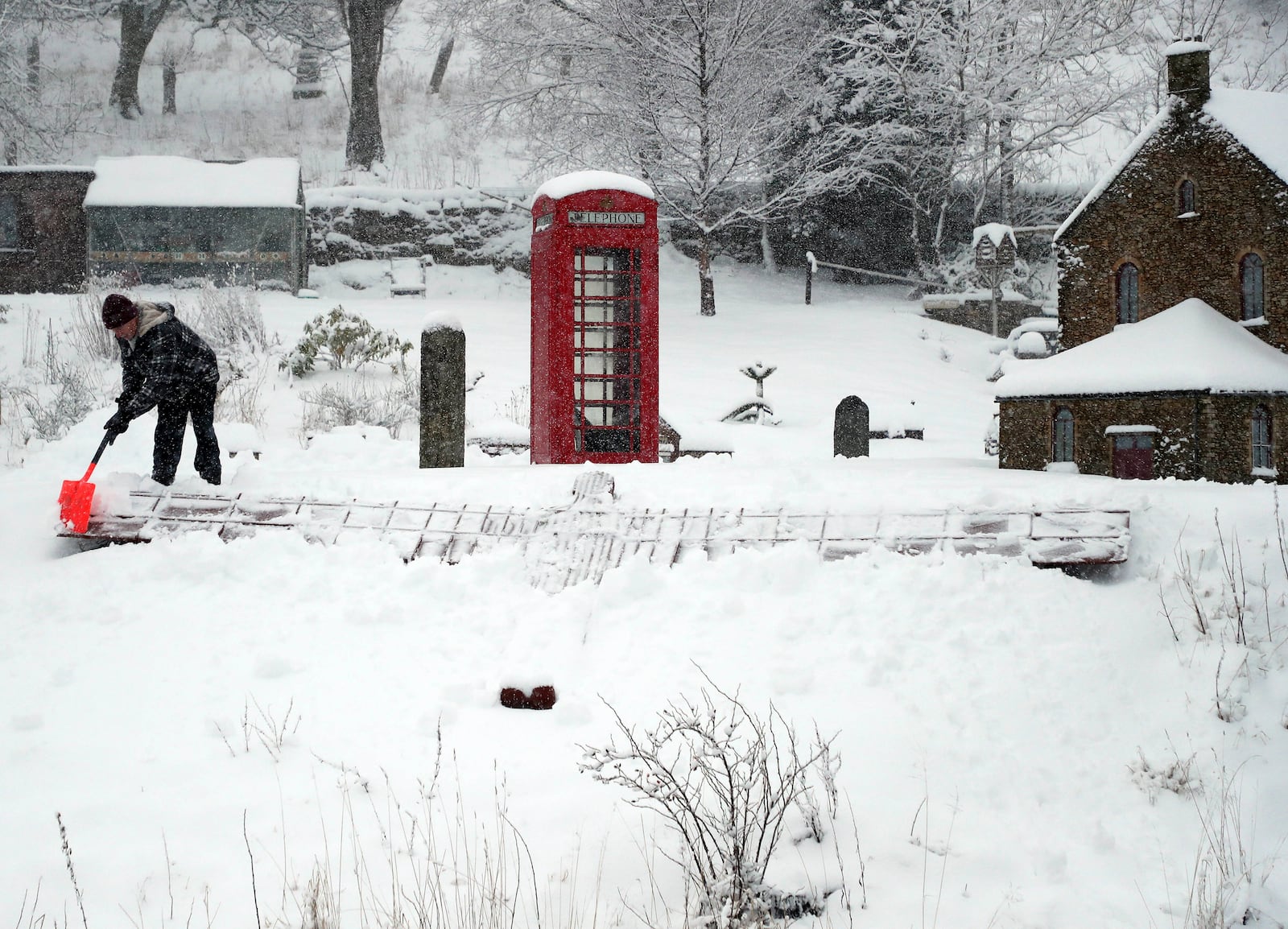 Lowson Robinson is pictured in the heavy snow with his scaled miniature famous landmarks which are located in his garden in Nenthead, England, as the severe weather continues across England, Sunday, Jan. 5, 2025. (AP Photo/Scott Heppell)