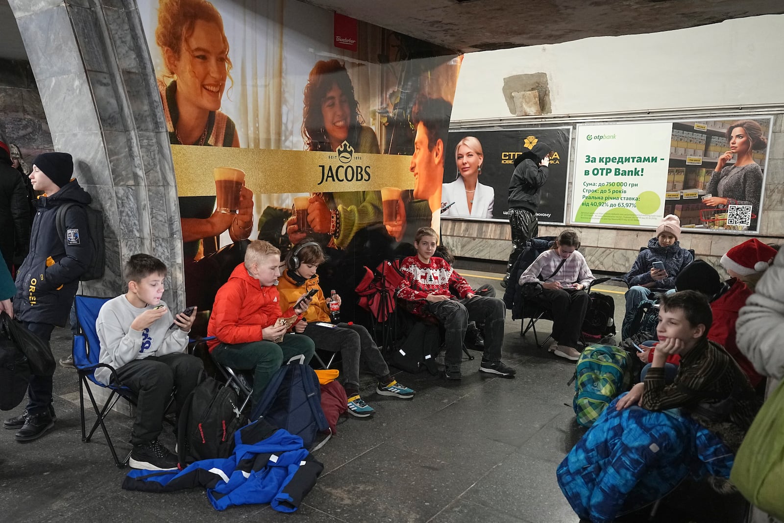 People take shelter in a metro station during an air raid alarm in Kyiv, Ukraine, Friday, Dec. 20, 2024. (AP Photo/Efrem Lukatsky)