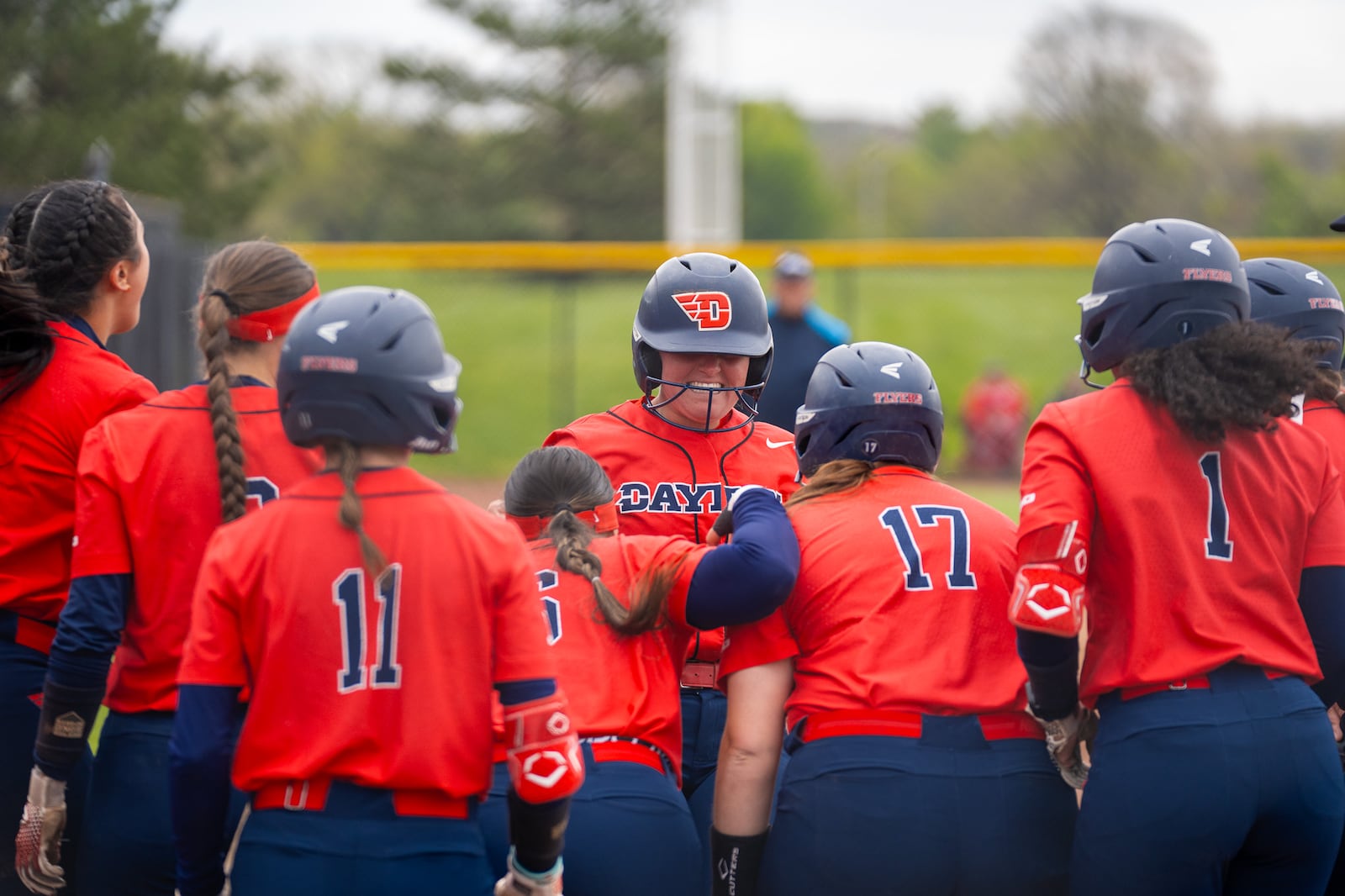 The Dayton softball team celebrates a run during a game against St. Joseph's on April 21, 2024, in Dayton. UD photo