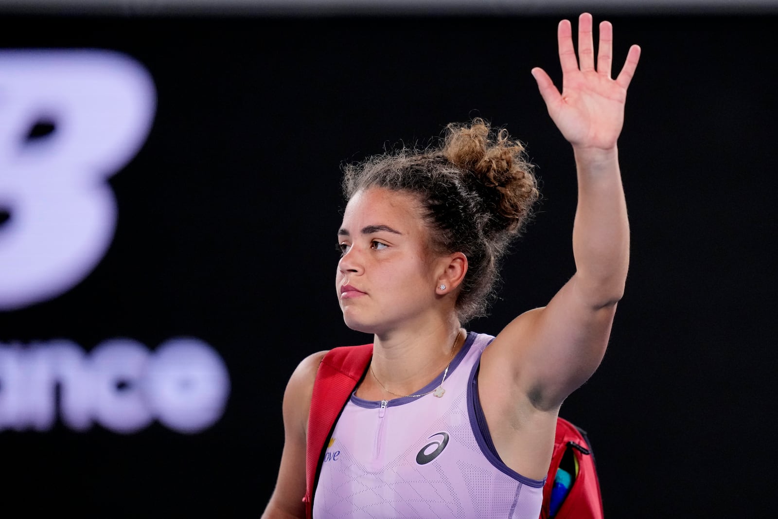 Jasmine Paolini of Italy waves as she leaves the court following her third round loss to Elina Svitolina of Ukraine at the Australian Open tennis championship in Melbourne, Australia, Saturday, Jan. 18, 2025. (AP Photo/Vincent Thian)