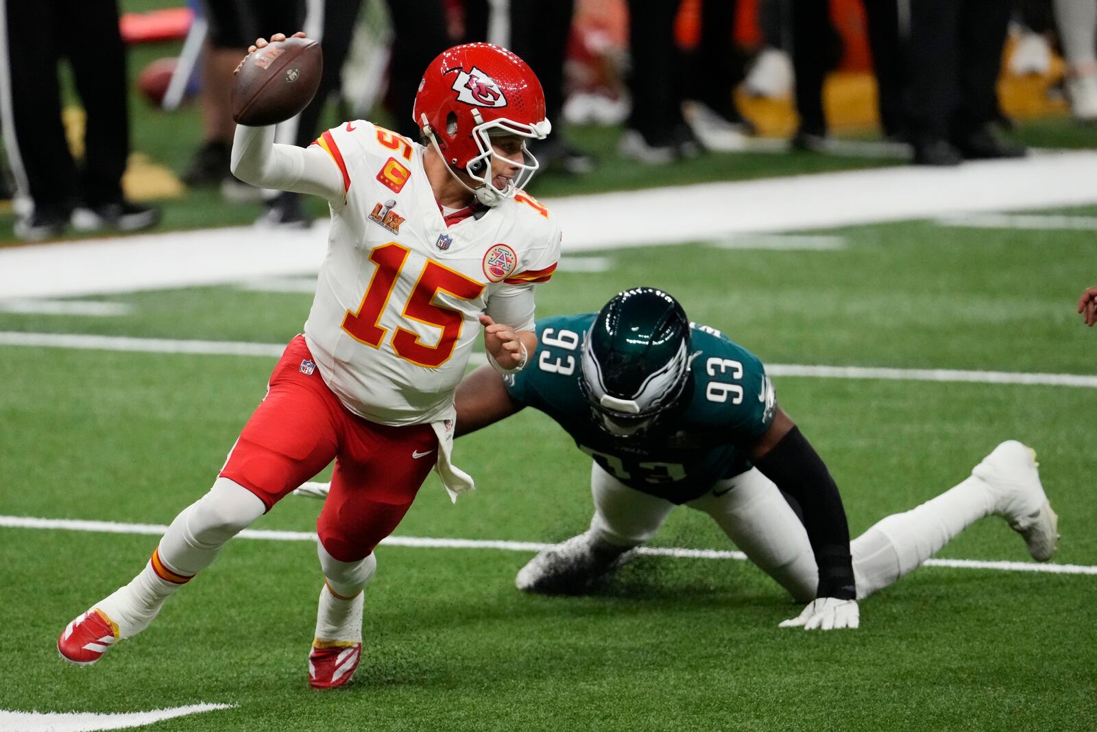 Kansas City Chiefs quarterback Patrick Mahomes (15) eludes the tackle of Philadelphia Eagles defensive tackle Milton Williams (93) during the first half of the NFL Super Bowl 59 football game, Sunday, Feb. 9, 2025, in New Orleans. (AP Photo/Gerald Herbert)