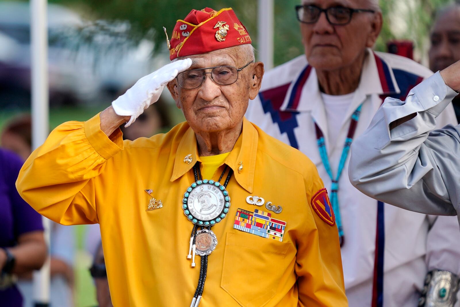 FILE - Navajo Code Talker Thomas Begay salutes during the national anthem at the Arizona State Navajo Code Talkers Day celebration, Aug. 14, 2022, in Phoenix. (AP Photo/Ross D. Franklin, File)