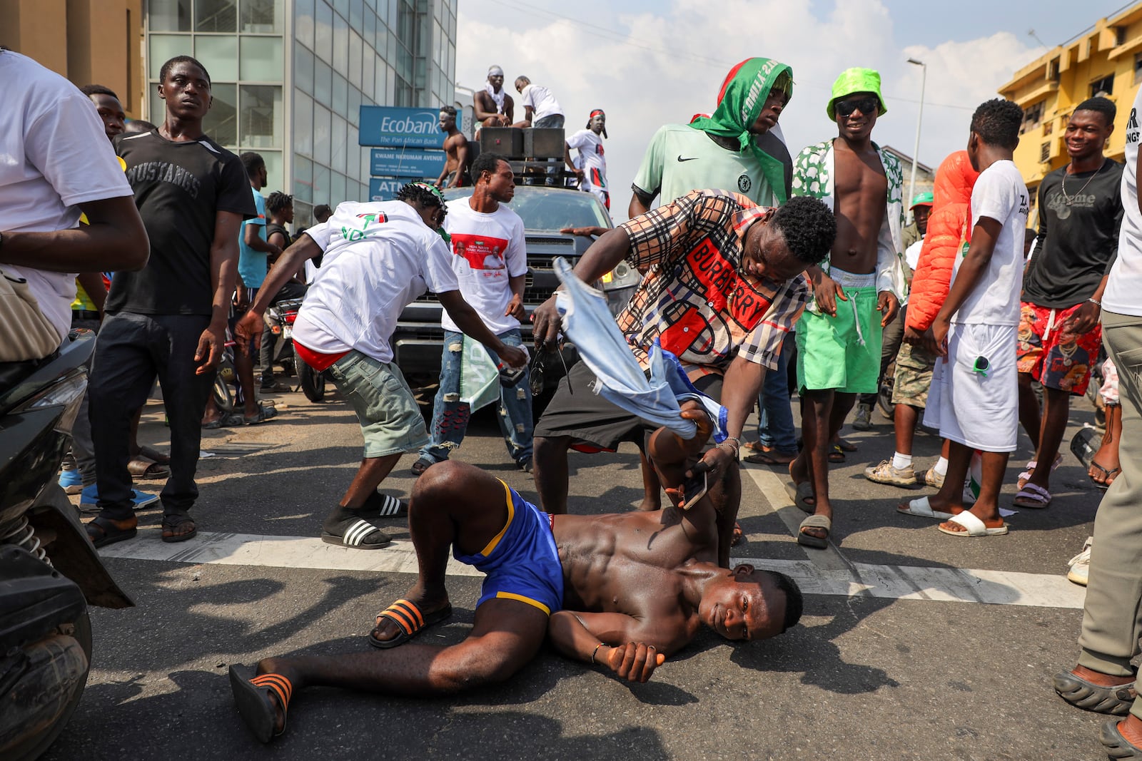 Supporters of opposition candidate and former President John Dramani Mahama celebrate their victory after Ghana's vice president and ruling party candidate, Mahamudu Bawumia conceded his defeat in Accra, Ghana, Sunday, Dec. 8, 2024. (AP Photo/Misper Apawu)