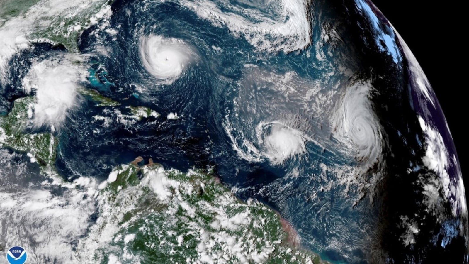 This Sept. 11, 2018 enhanced satellite image made available by NOAA shows Tropical Storm Florence, upper left, in the Atlantic Ocean, Tropical Storm Isaac, center, and at right Hurricane Helene. On Thursday, May 23, 2019, The National Oceanic and Atmospheric Administration says the Atlantic hurricane season should be near normal. NOAA predicted nine to 15 named storms. It says four to eight of them will become hurricanes and two to four of those major hurricanes with 111 mph winds or higher.  