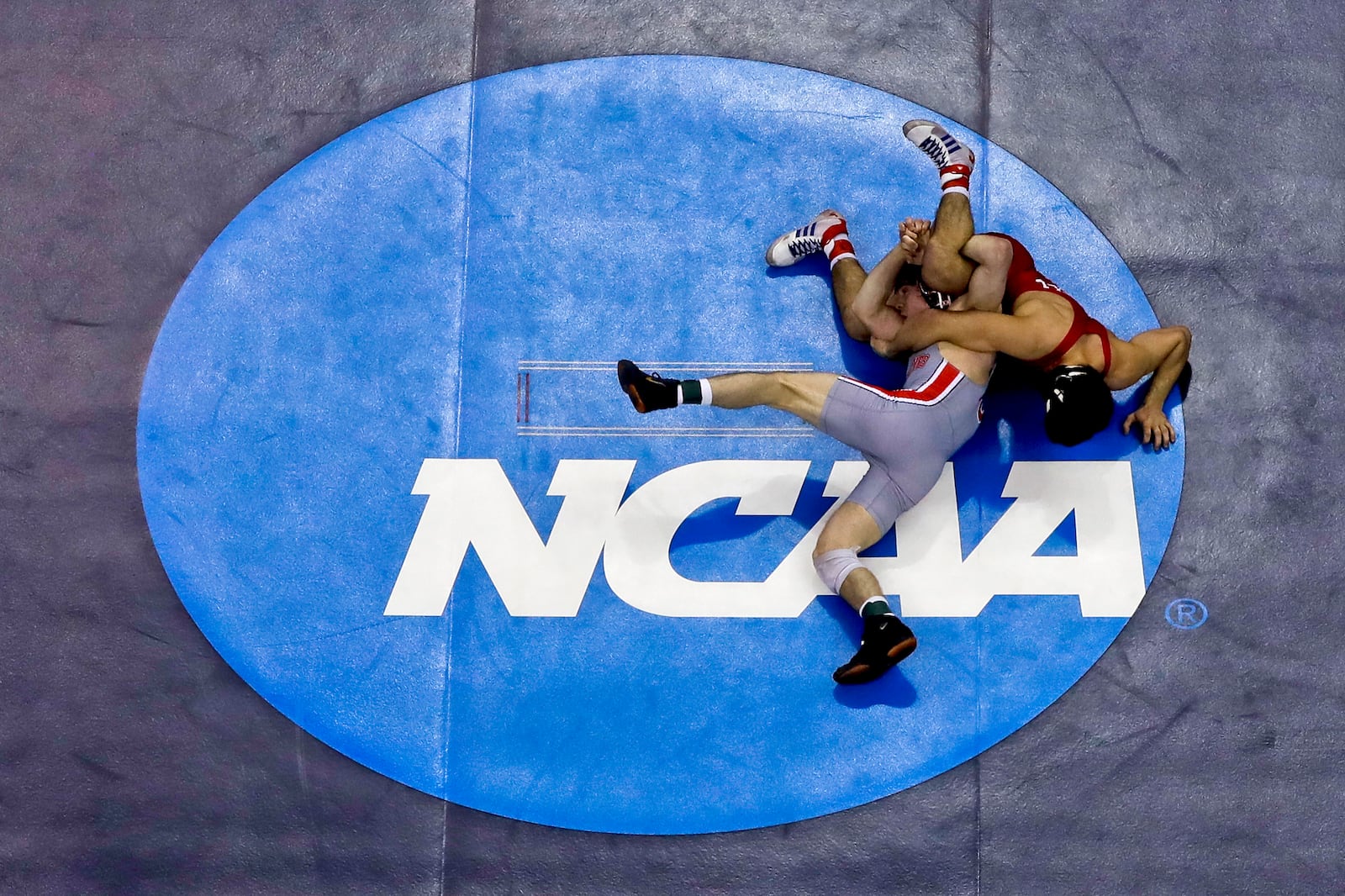 FILE - Cornell's Yianni Diakomihalis, right, controls Ohio State's Joey McKenna in their 141-pound match in the finals of the NCAA wrestling championships Saturday, March 23, 2019 in Pittsburgh.(AP Photo/Gene J. Puskar, File)