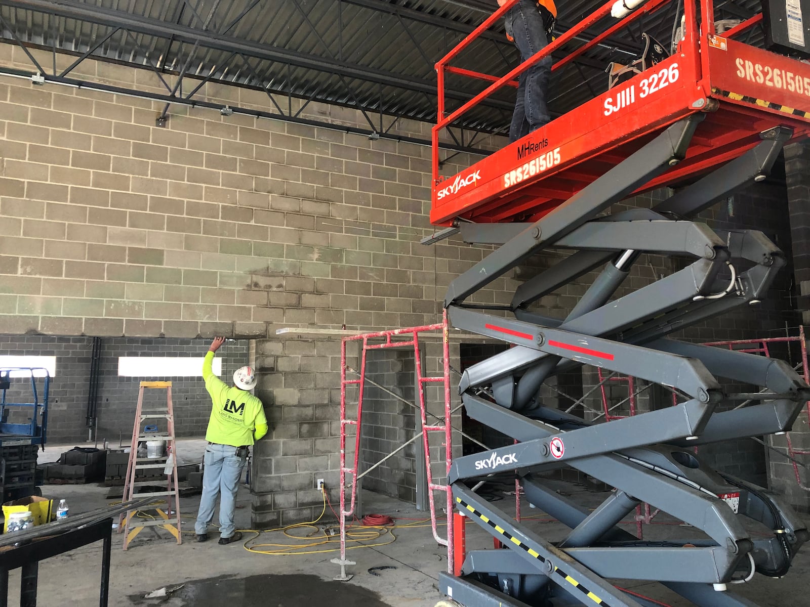 Masonry crews work on the walls of the new West Carrollton Early Childhood Center on Friday, Sept. 24, 2021. The ECC will house the school district's preschool, kindergarten and first grade students starting in fall 2022.