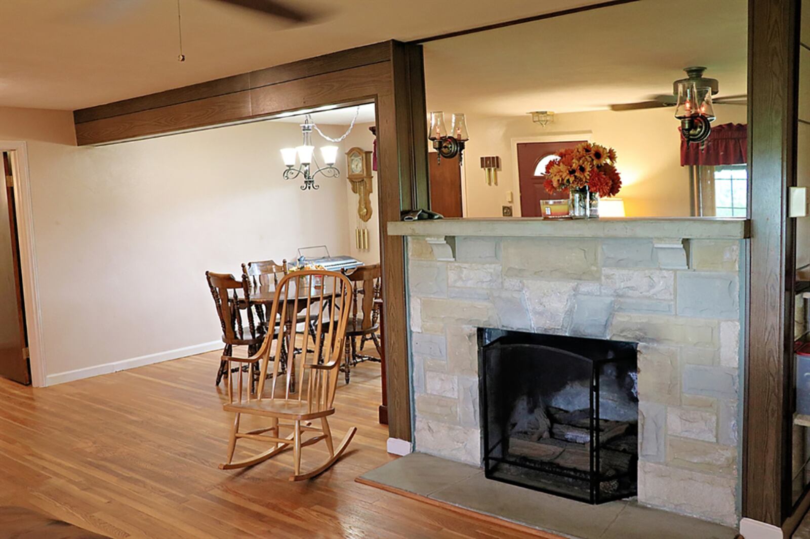 A wood-cross beam accents the entry into the dining area, and a vent-less gas fireplace has a stone hearth and mantel. CONTRIBUTED PHOTO BY KATHY TYLER