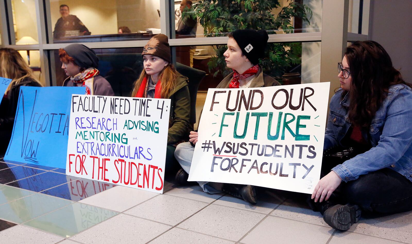 Wright State University students held a sit-in at the president's office front door and professors picketed in front of campus on Thursday while president Cheryl Schrader taught an engineering class in the Russ Center.  TY GREENLEES / STAFF