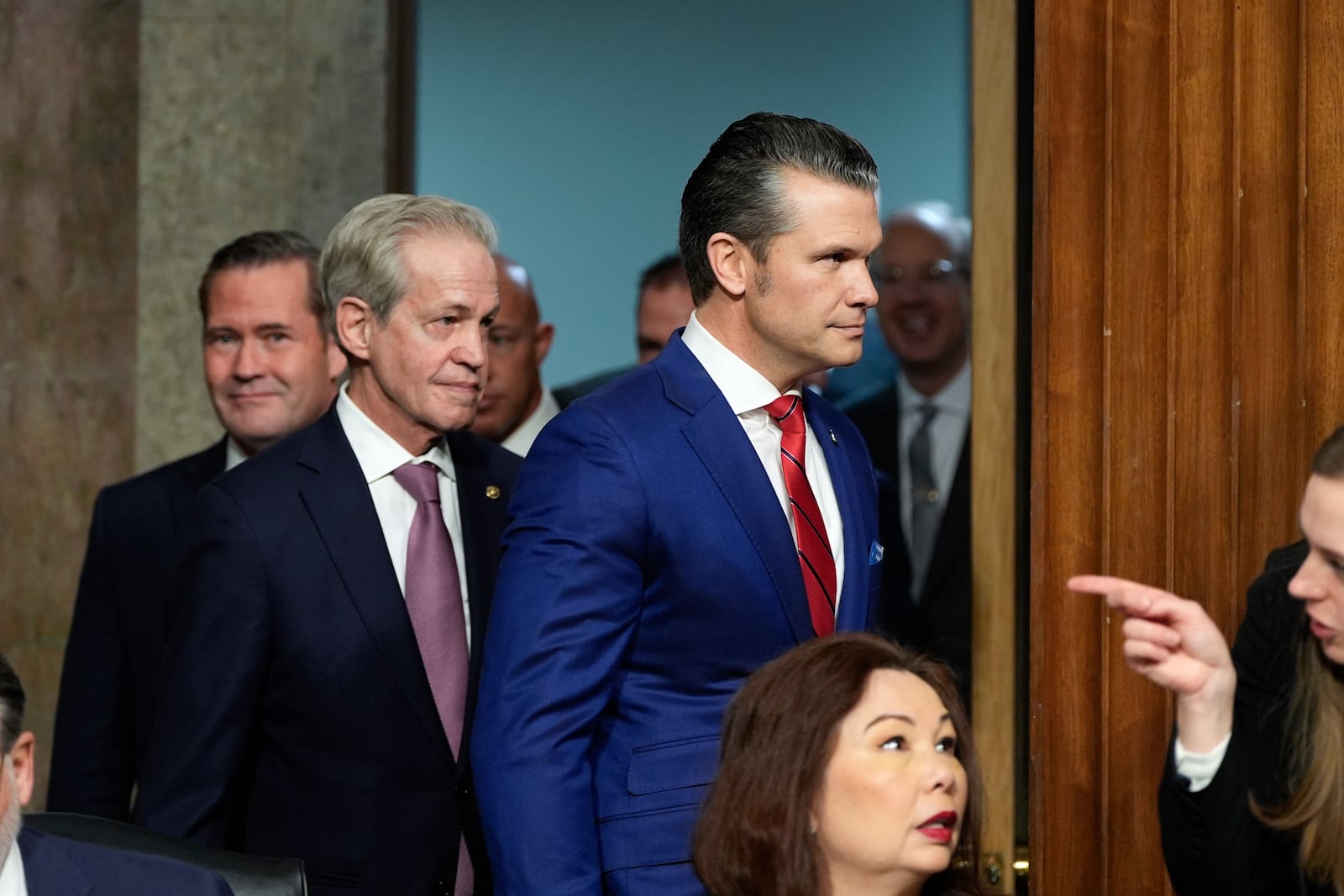 Pete Hegseth, right, President-elect Donald Trump's choice to be Defense secretary, arrives with former Sen. Norm Coleman, left, before the Senate Armed Services Committee for his confirmation hearing, at the Capitol in Washington, Tuesday, Jan. 14, 2025. (AP Photo/Alex Brandon)